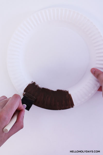 A paper plate gets painted brown for the Ramadan Drummer's beard.