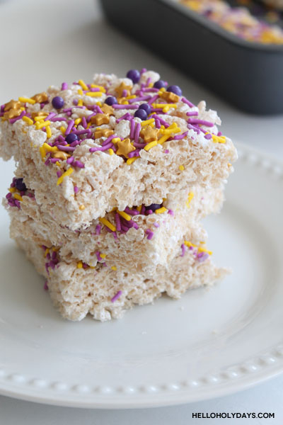 Rice krispy treats are stacked on a plate.