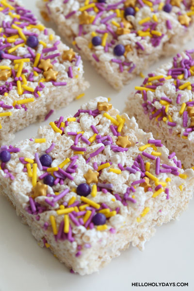 Rice krispy treats cut in squares on a plate.